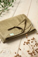 Light green linen pram blanket for a baby