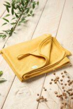 Yellow linen stroller blanket for a baby